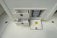 Storage compartments on a 2027 Cobia 320 Center Console boat.