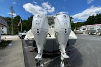 2027 Cobia 320 Center Console with twin Yamaha 350 V6 engines at a boat dealership.