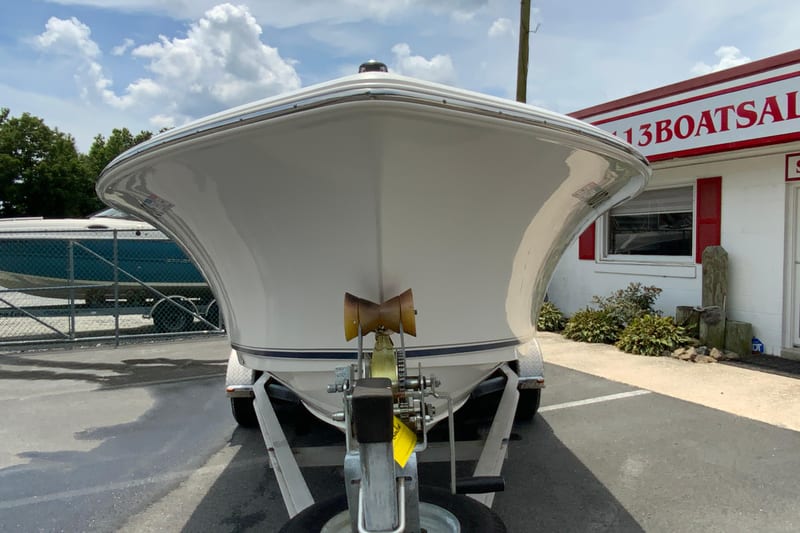2014 Sea Hunt Escape 211 LE boat on trailer, parked outside dealership.