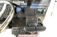 Control panel of 2027 Pursuit S 268 Sport boat with steering wheel and electronic displays.