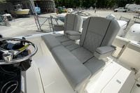 2027 Pursuit S 268 Sport boat interior with gray cushioned seating and steering wheel.