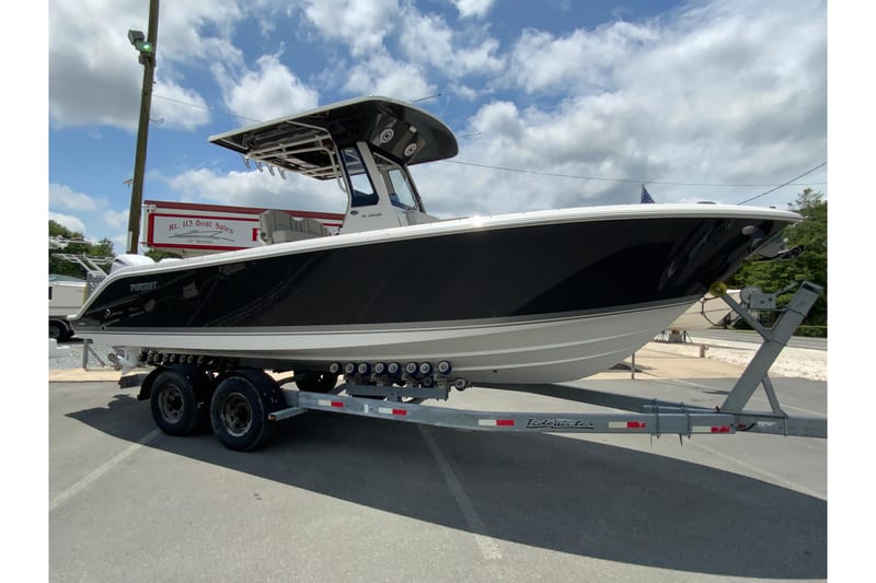 2027 Pursuit S 268 Sport boat on trailer under cloudy sky.