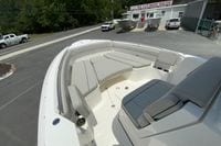 2027 Pursuit S 268 Sport boat with spacious seating at a boat sales lot.