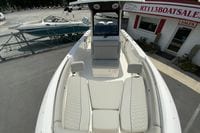 2027 Pursuit S 268 Sport boat with spacious seating at a boat sales lot.