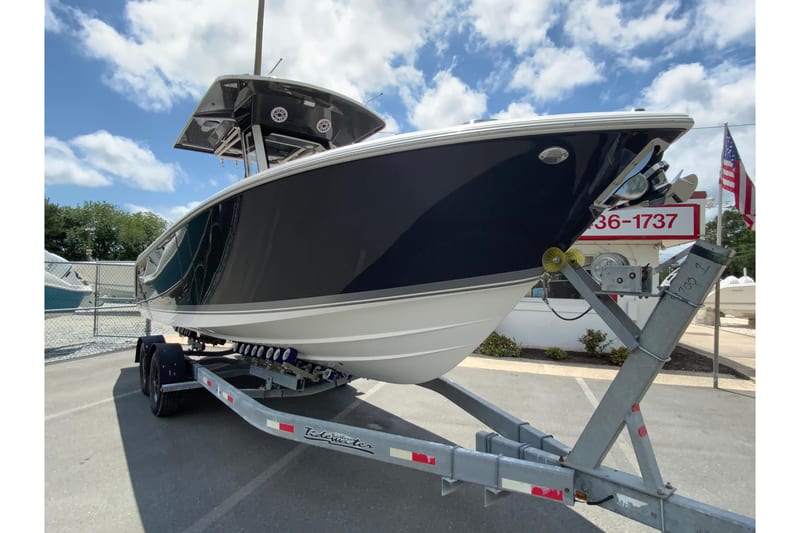 2027 Pursuit S 268 Sport boat on trailer under a clear blue sky.