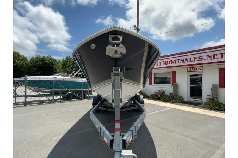 2027 Pursuit S 268 Sport boat on trailer at dealership under blue sky.