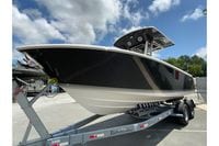 2027 Pursuit S 268 Sport boat on trailer under a partly cloudy sky.