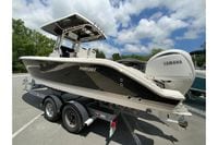 2027 Pursuit S 268 Sport boat on trailer with Yamaha engine, parked outdoors.