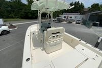 2023 Pathfinder 2400 TRS boat at dealership, featuring center console and rod holders.