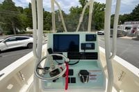 2023 Pathfinder 2400 TRS boat console with steering wheel and navigation equipment.