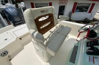 2023 Pathfinder 2400 TRS boat seat with steering wheel and controls in a sales lot.