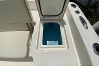 Open storage compartment on 2023 Pathfinder 2400 TRS boat deck.
