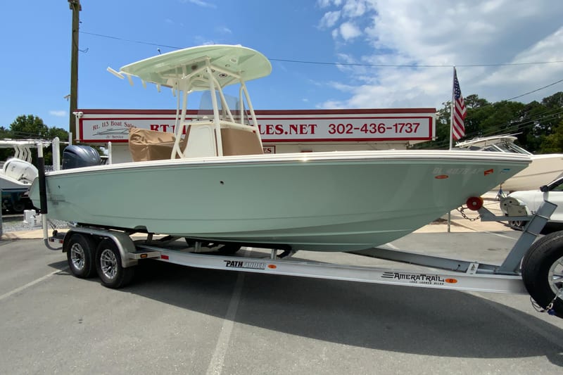 2023 Pathfinder 2400 TRS boat on trailer at dealership, clear sky background.