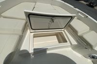 2023 Pathfinder 2400 TRS boat with open storage compartment and cushioned seating.