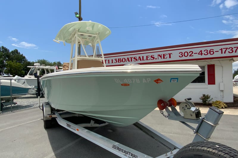 2023 Pathfinder 2400 TRS boat on trailer at dealership, clear sky background.