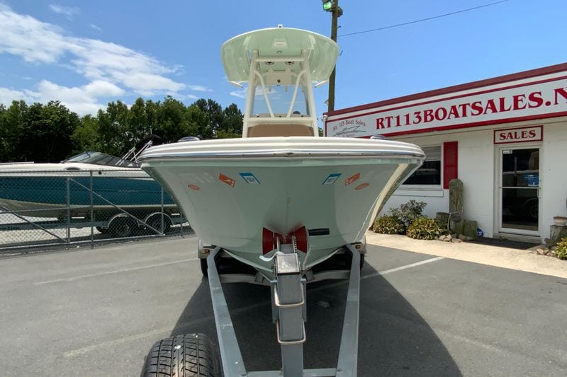 2023 Pathfinder 2400 TRS boat on trailer at dealership, clear sky background.