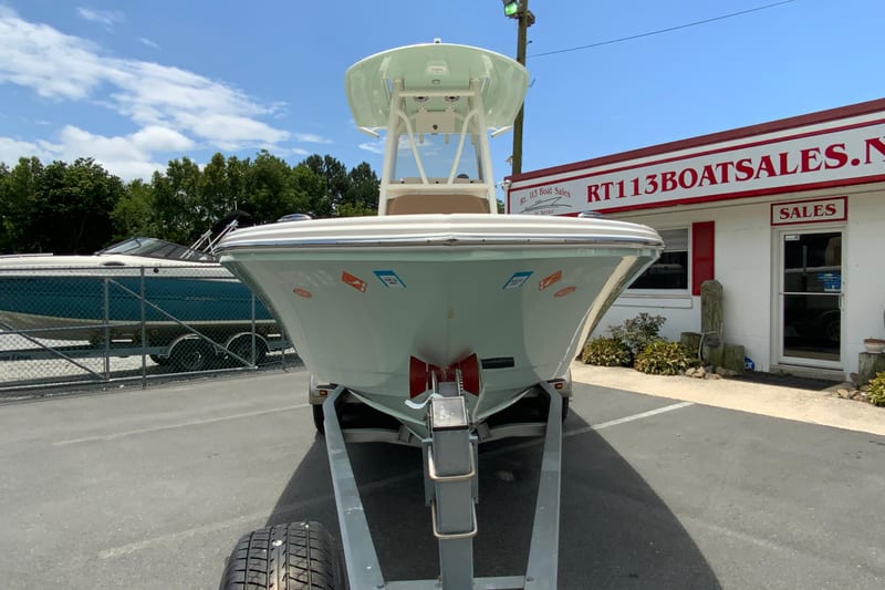 2023 Pathfinder 2400 TRS boat on trailer at dealership, clear sky background.