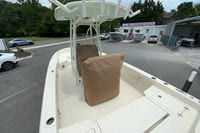 2023 Pathfinder 2400 TRS boat at dealership, featuring covered seats and spacious deck.