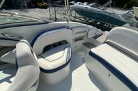 2019 Crownline Eclipse E235 XS boat interior with white and blue seating, docked outdoors.