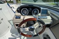 2019 Crownline Eclipse E235 XS boat dashboard with gauges, controls, and wooden steering wheel.