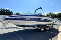 2019 Crownline Eclipse E235 XS boat on trailer, parked outdoors under clear sky.