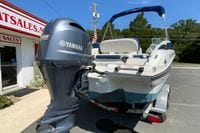 2019 Crownline Eclipse E235 XS boat with Yamaha outboard motor, parked near sales building.