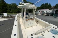 2018 Cobia 301 Center Console boat at dealership, showcasing spacious deck and seating.