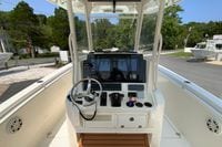 2018 Cobia 301 Center Console boat dashboard with steering wheel and navigation controls.