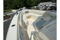 2018 Cobia 301 Center Console boat interior at dealership, showcasing seating and speakers.