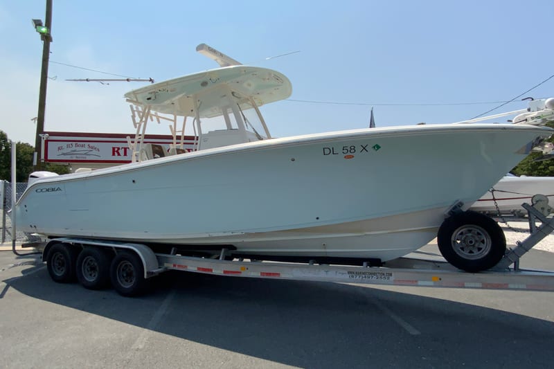 2018 Cobia 301 Center Console boat on a trailer at a dealership.