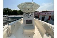 2018 Cobia 301 Center Console boat at dealership, showcasing spacious deck and seating.