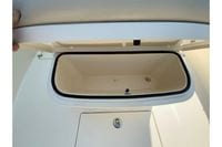 Open storage compartment on 2018 Cobia 301 Center Console boat.