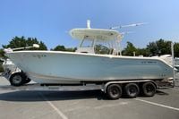 2018 Cobia 301 Center Console boat on a trailer, parked outdoors.