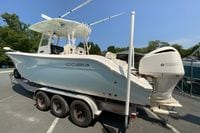 2018 Cobia 301 Center Console boat on trailer with Yamaha engine, parked outdoors.