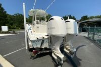 2018 Cobia 301 Center Console boat with twin Yamaha engines in a parking lot.