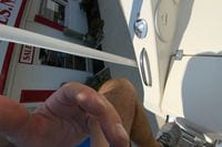 2018 Cobia 301 Center Console near sales office, partial view with hand and foot.
