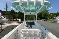 2023 Sportsman Open 232 Center Console boat with T-top and modern dashboard.