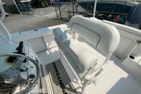 2023 Sportsman Open 232 Center Console boat interior with white seating and steering wheel.