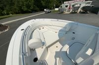 2023 Sportsman Open 232 Center Console boat at dealership, showcasing spacious seating area.