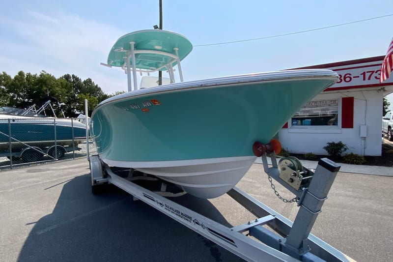 2023 Sportsman Open 232 Center Console boat on trailer, teal hull, outdoor dealership.