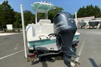 2023 Sportsman Open 232 Center Console boat with Yamaha 250 engine, parked outdoors.