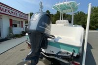 2023 Sportsman Open 232 Center Console boat with Yamaha 250 engine, parked outside dealership.