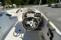 2010 Hurricane SunDeck Sport 200 OB boat cockpit with steering wheel and controls.