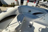 2010 Hurricane SunDeck Sport 200 OB boat interior with white seating and cup holders.