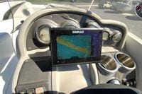Dashboard of 2010 Hurricane SunDeck Sport 200 OB with Simrad navigation display.