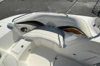 2010 Hurricane SunDeck Sport 200 OB boat interior with damaged seating and storage compartments.