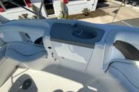 Interior view of 2010 Hurricane SunDeck Sport 200 OB boat with seating and sink.