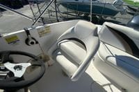 Captain's seat and steering wheel of 2010 Hurricane SunDeck Sport 200 OB boat.