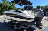 2010 Hurricane SunDeck Sport 200 OB boat with Yamaha outboard motor on trailer.