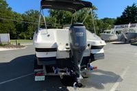 2010 Hurricane SunDeck Sport 200 OB boat with Yamaha 150 engine, parked outdoors.